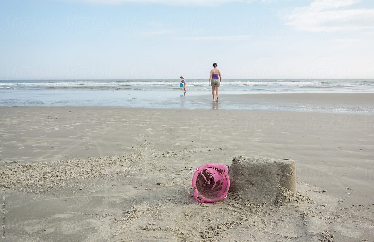 Mother and Daughter Build Sandcastle at the Beach