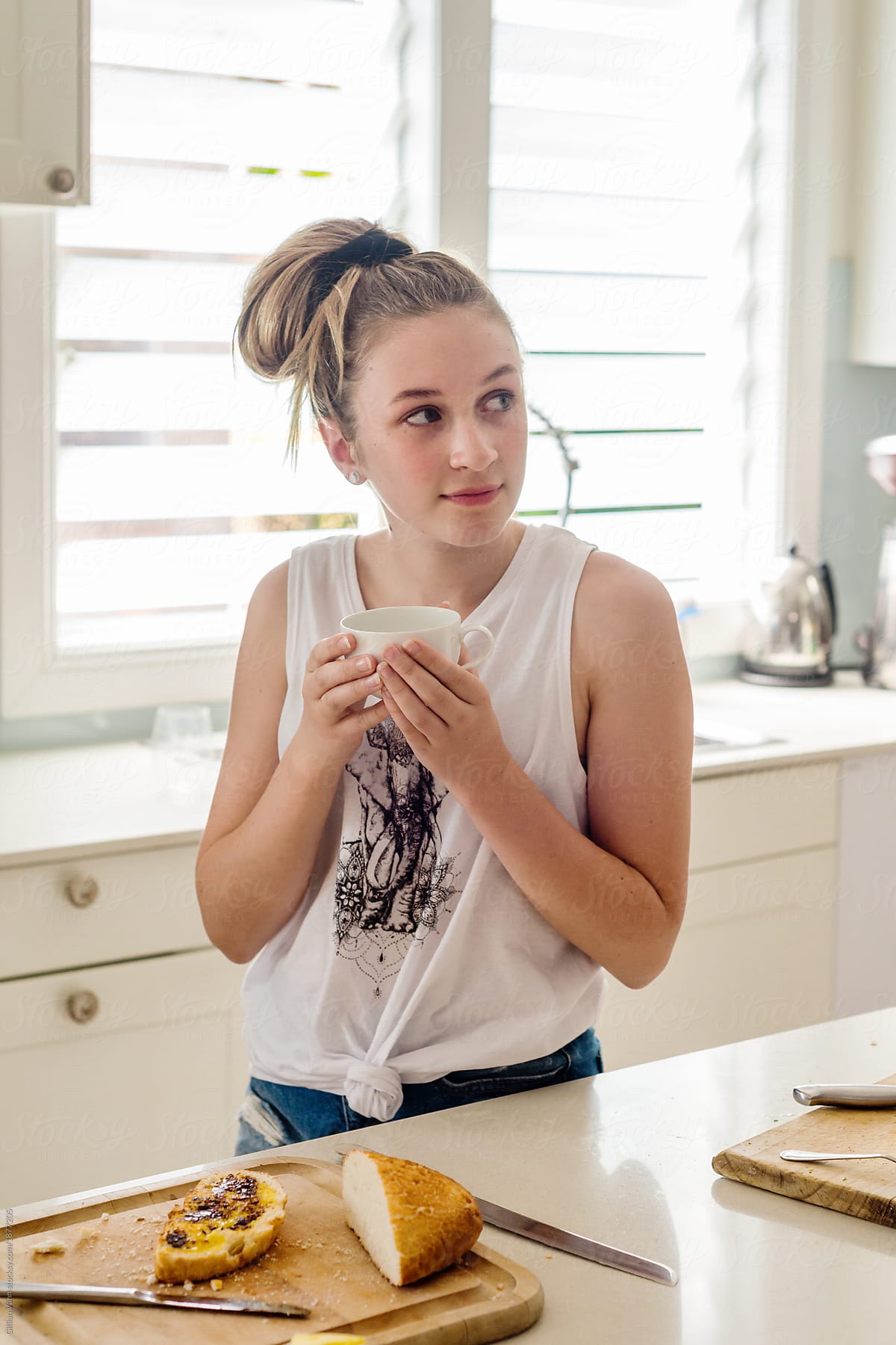 Teen In Kitchen With A Cup Of Tea By Stocksy Contributor Gillian Vann Stocksy