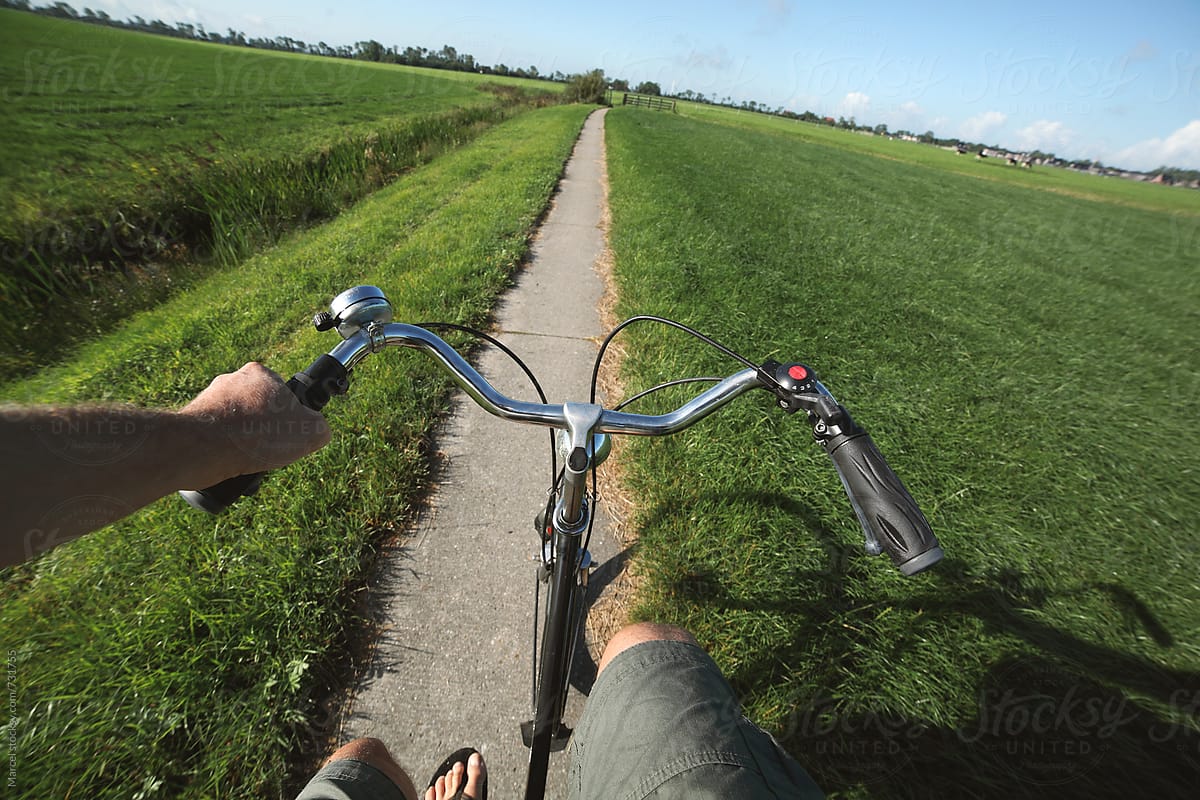 Man in shorts cycling on rural path