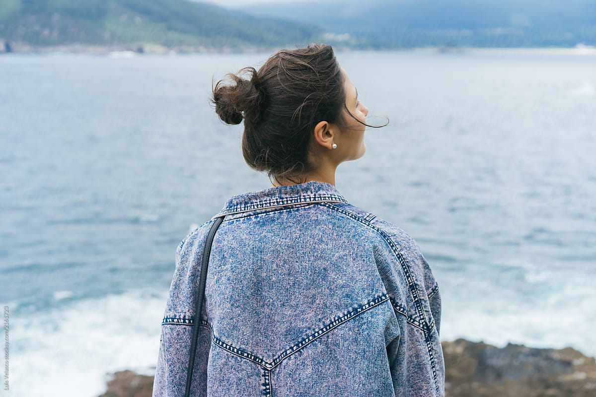Back Of A Girl Sights The Ocean From A Cliff By Stocksy Contributor Luis Velasco Stocksy