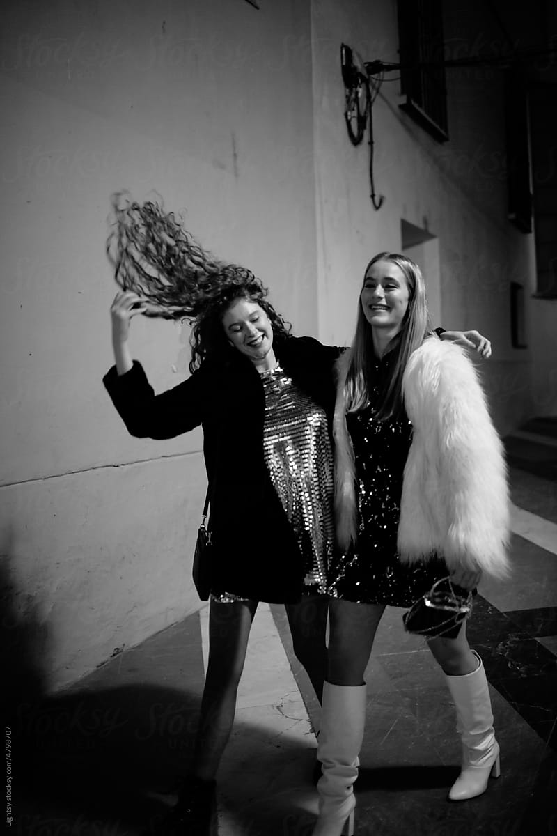 Women laughing in the street at night