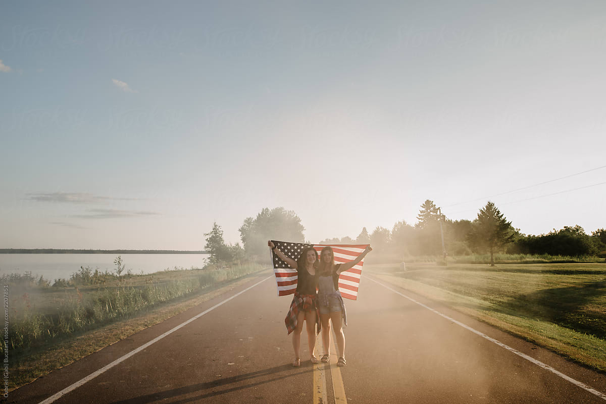 Girls Holding USA Flag on a Road