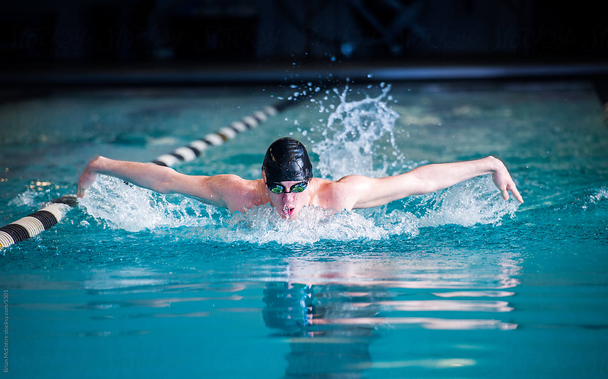 Male Swimmer Racing Toward Finish Performing Butterfly Stroke