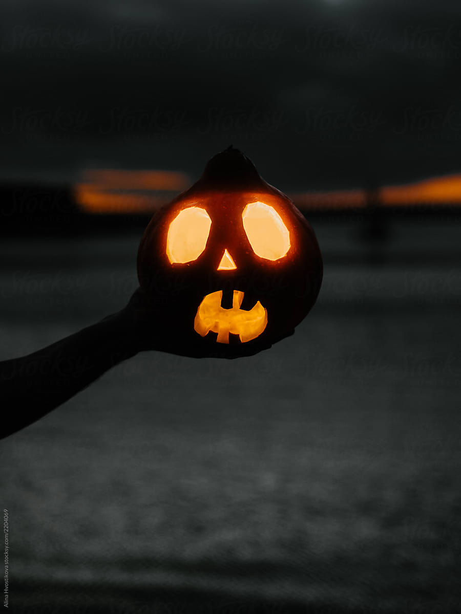 Hand of man holding Halloween pumpkin