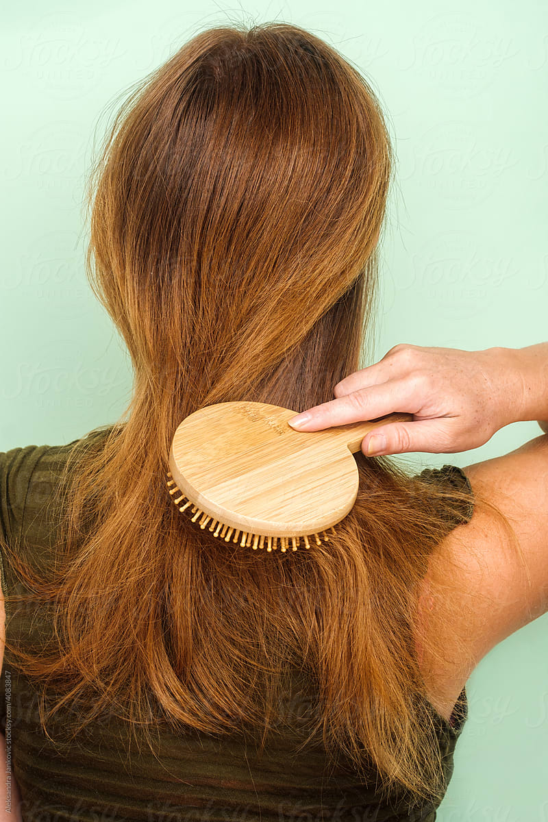 Anonymous Redhead Woman Brushing Her Hair