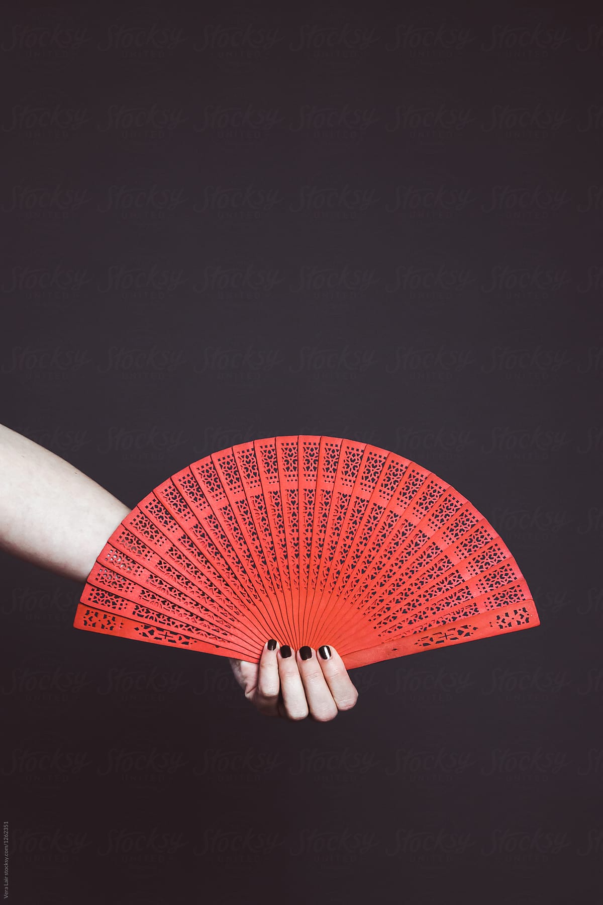 Woman holding a red fan