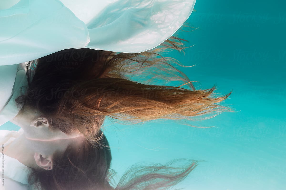 Surreal Image of a Woman Sneak Peek Underwater