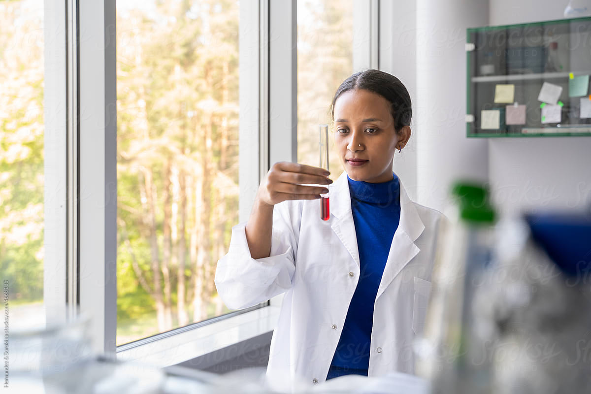 Black Woman Holding Sample In Lab