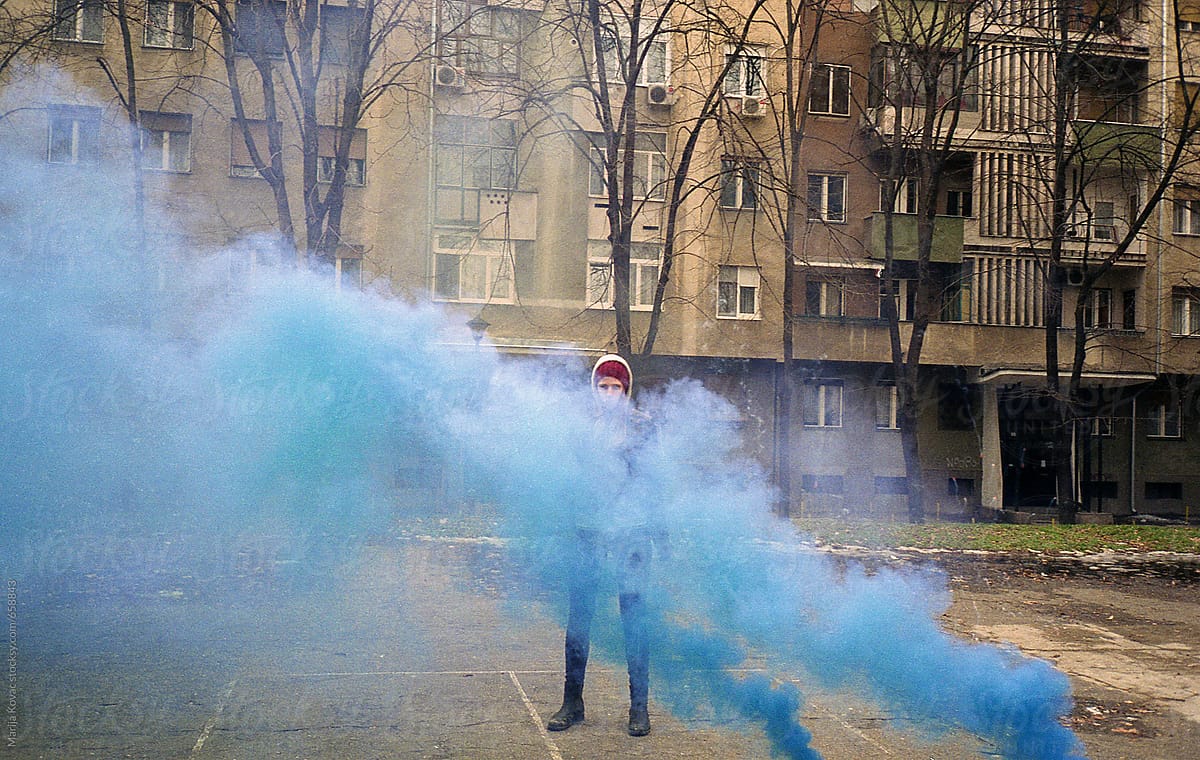 Girl behind a blue smoke