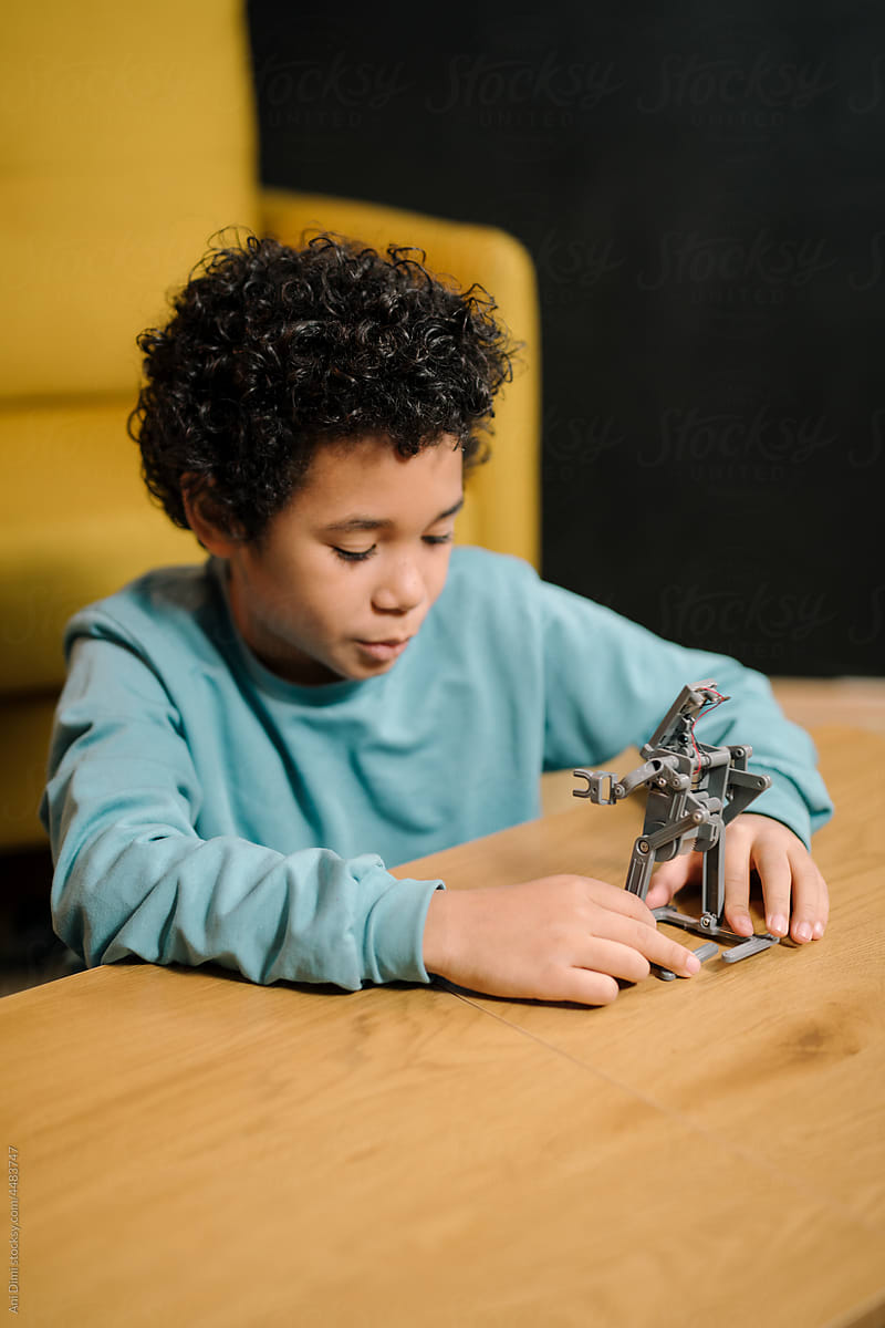 Boy plays with robot toy