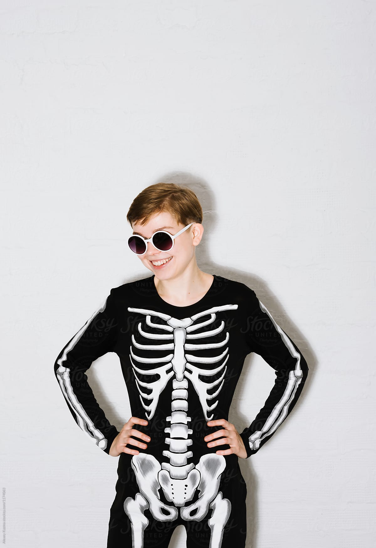 young woman in the Skeleton costume on the white brick backgroun