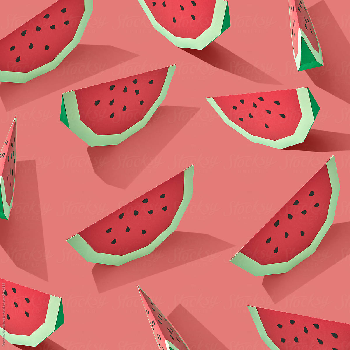 Pattern from handmade paper craft of slices of ripe organic watermelon on a pink background . Flat lay