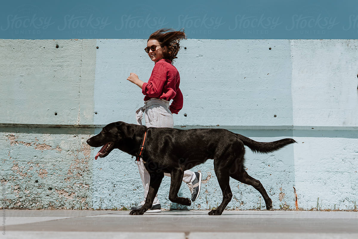 Woman and her dog running. Comfort friends