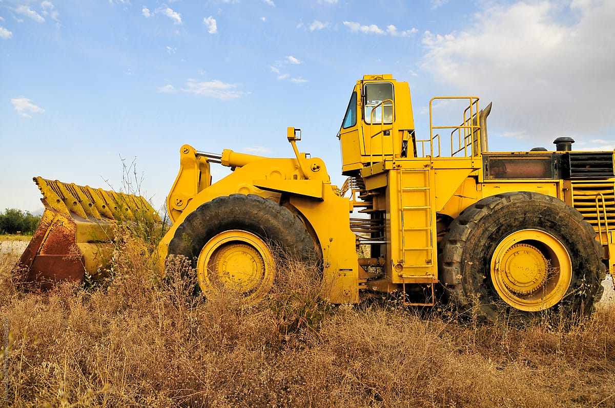 Yellow excavator on a field