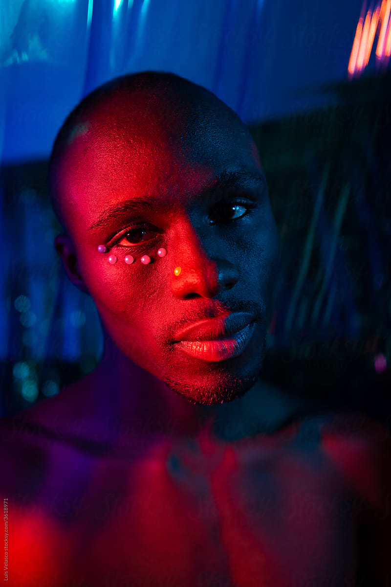 Blue And Red Portrait Of A Black With Creative Make Up.