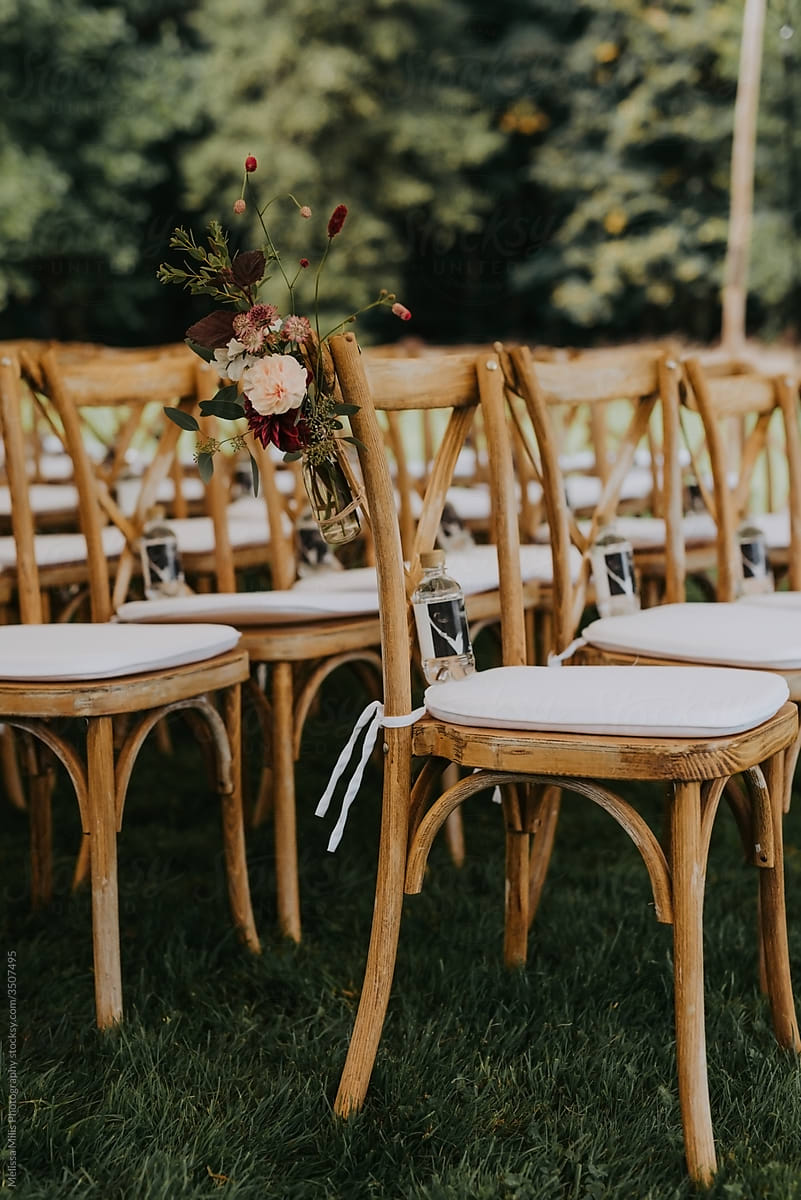 Rustic wooden chairs with beautiful flowers