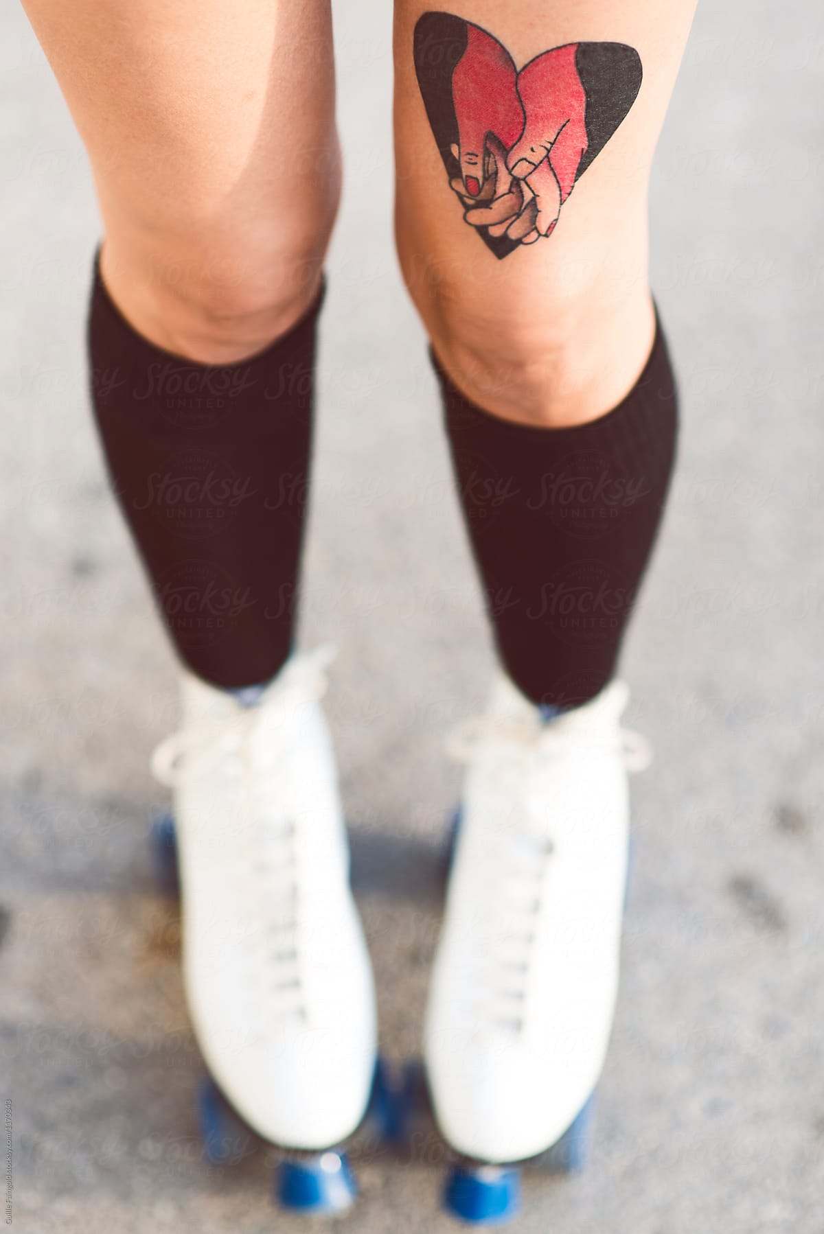 Girl with tattoo in rollerblades.