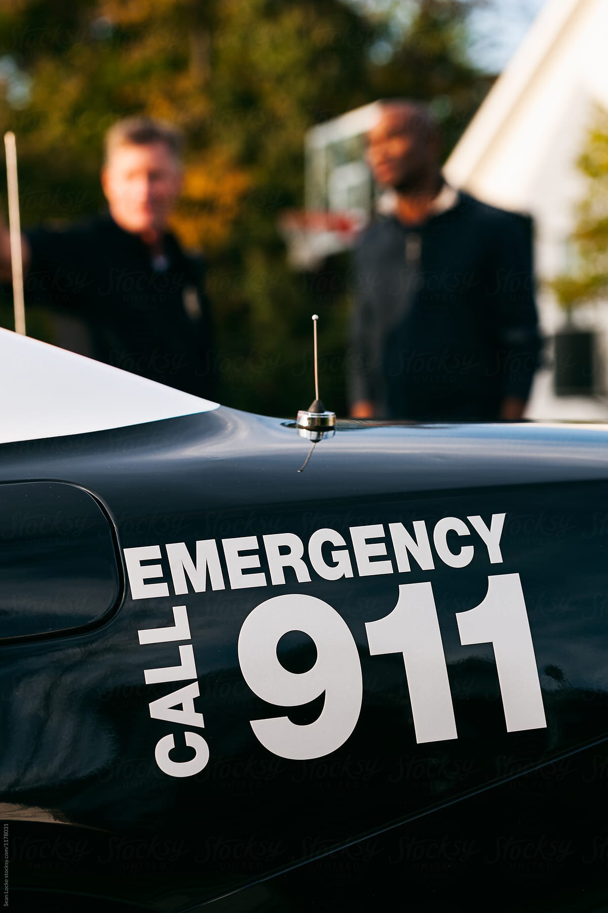 Police: Focus On 911 Car Label As a Person Talks With Officer