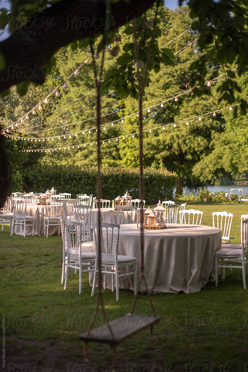 Wedding garden with white tables and outdoor light