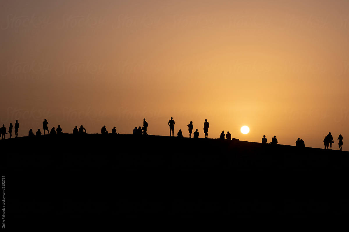 people silhouettes against sunset