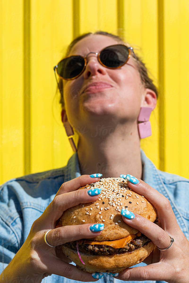 A woman enjoying a big burger