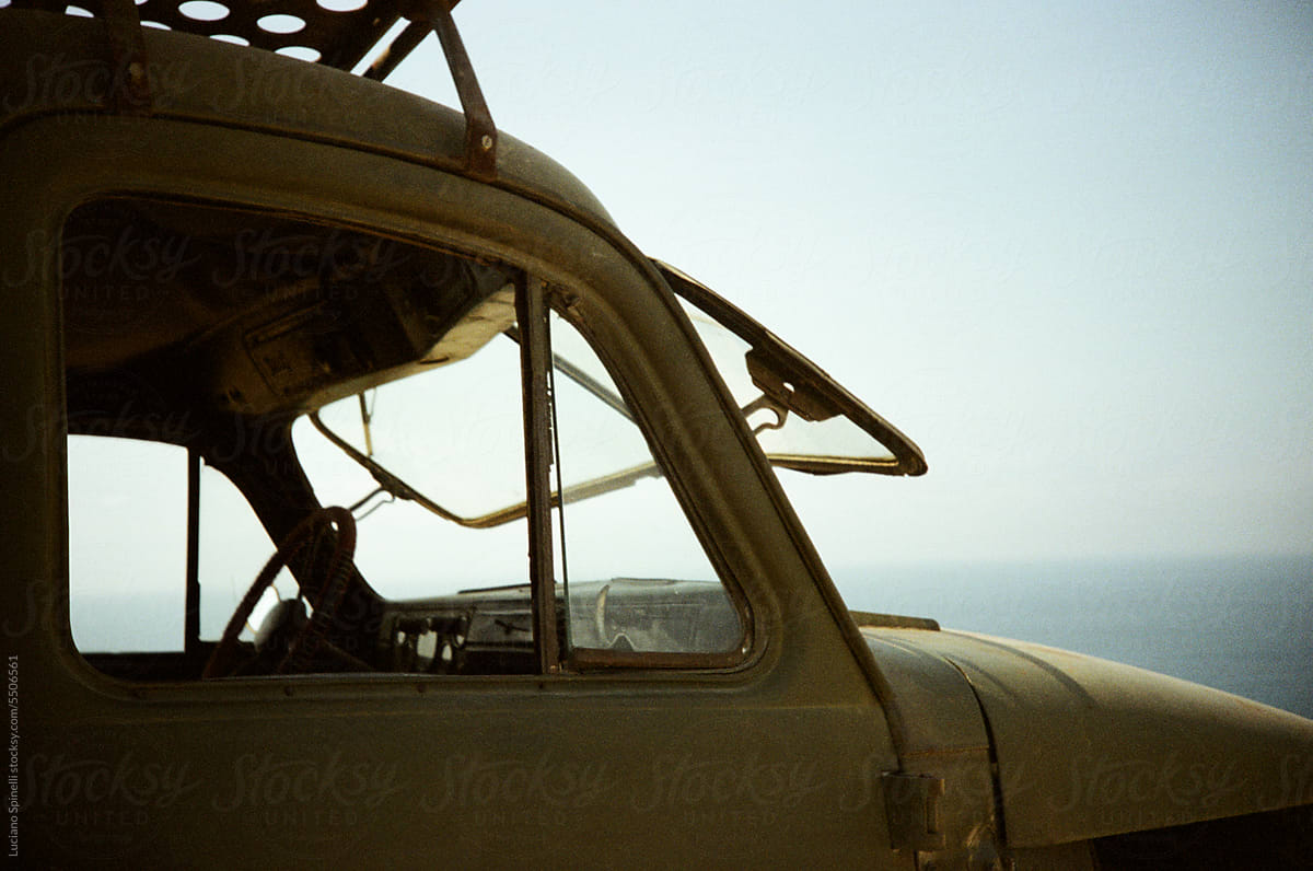 Vintage car facing the sea with windshield open