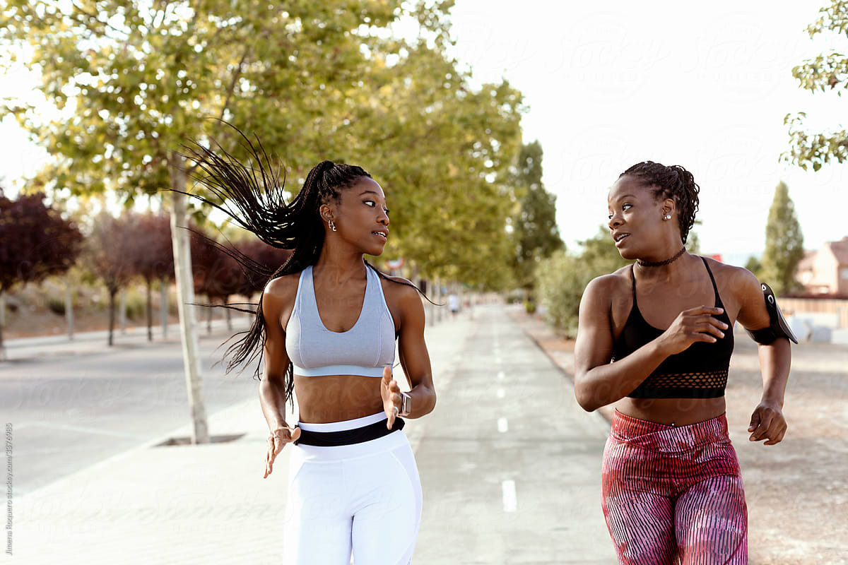 Two women friends running outdoors