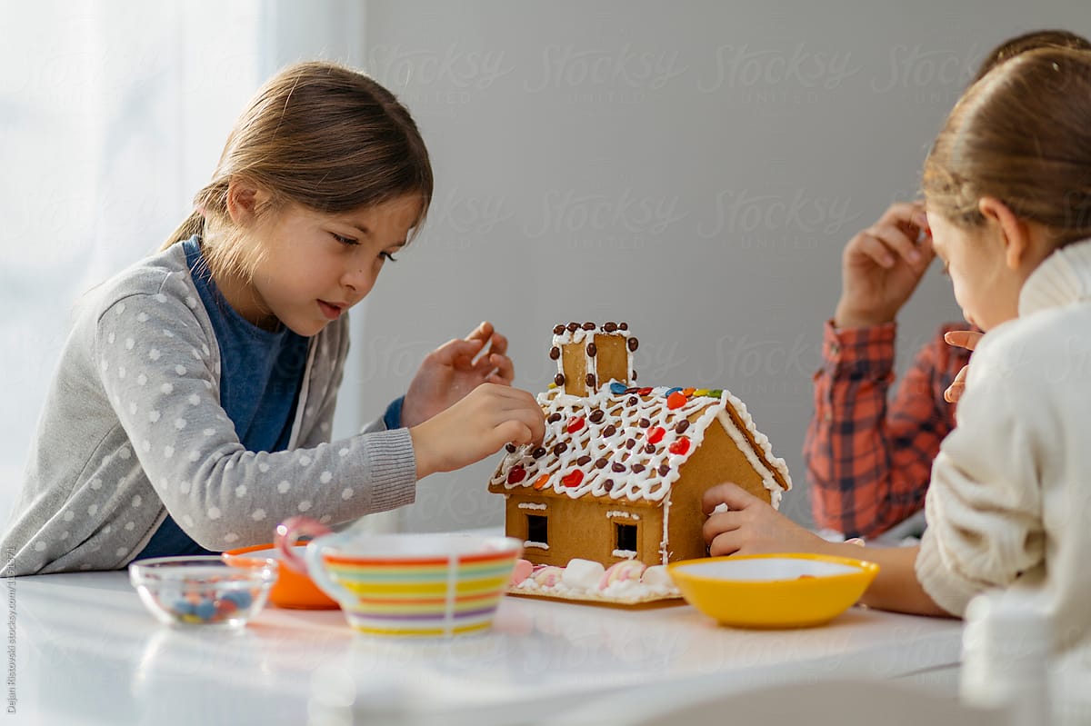 Children decorating Gingerbread house.