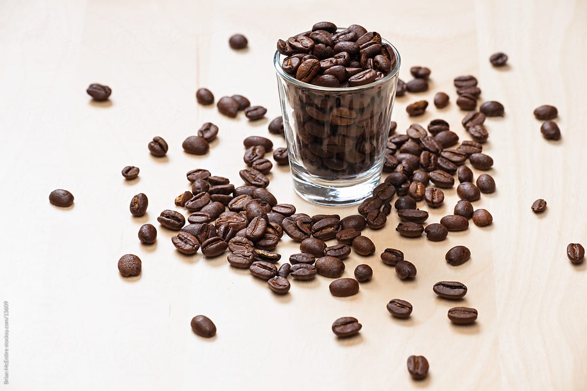 Coffee Beans Inside Shot Glass On Weight Scale With Empty Coffee