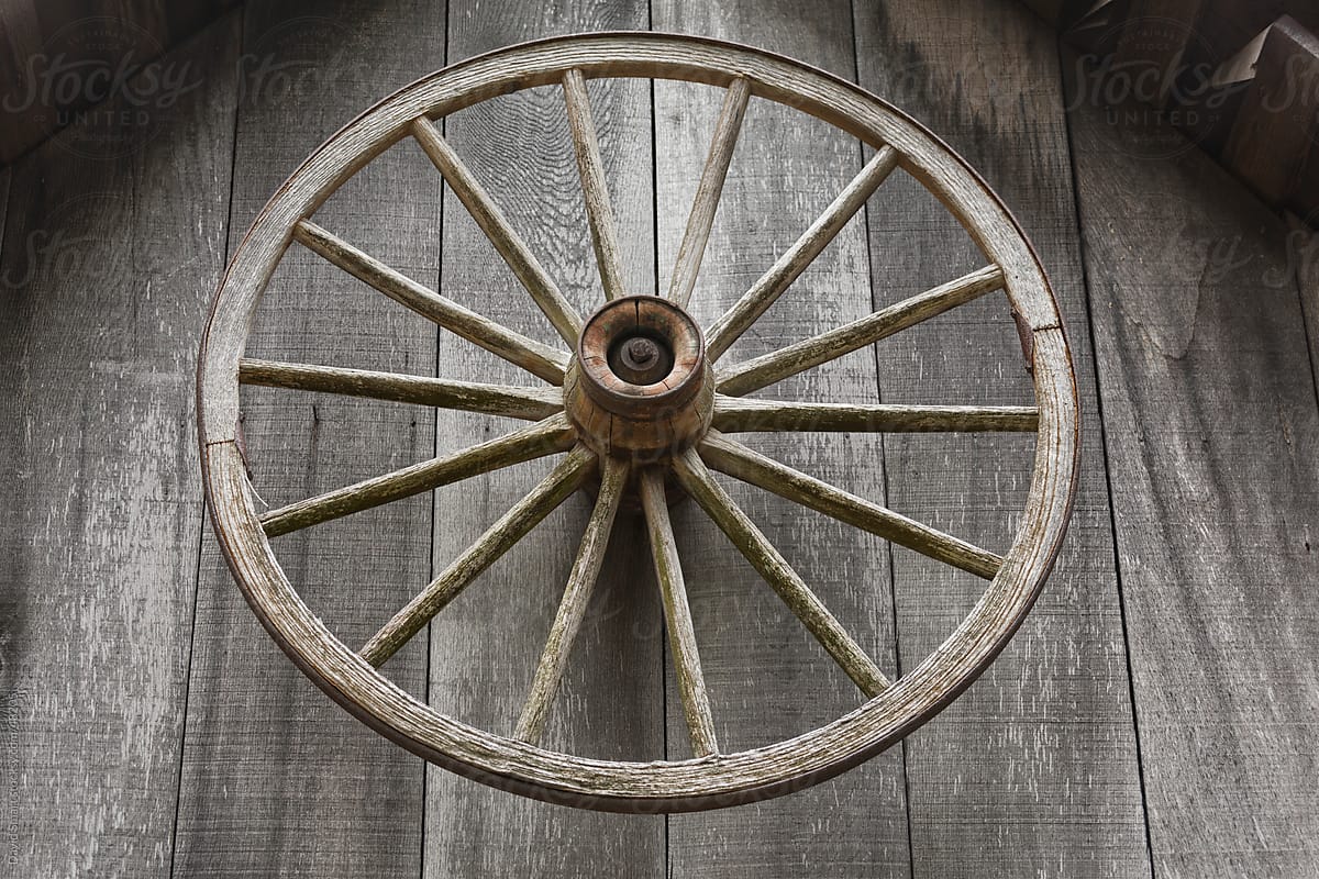 Old wagon wheel on front of a blacksmith shed