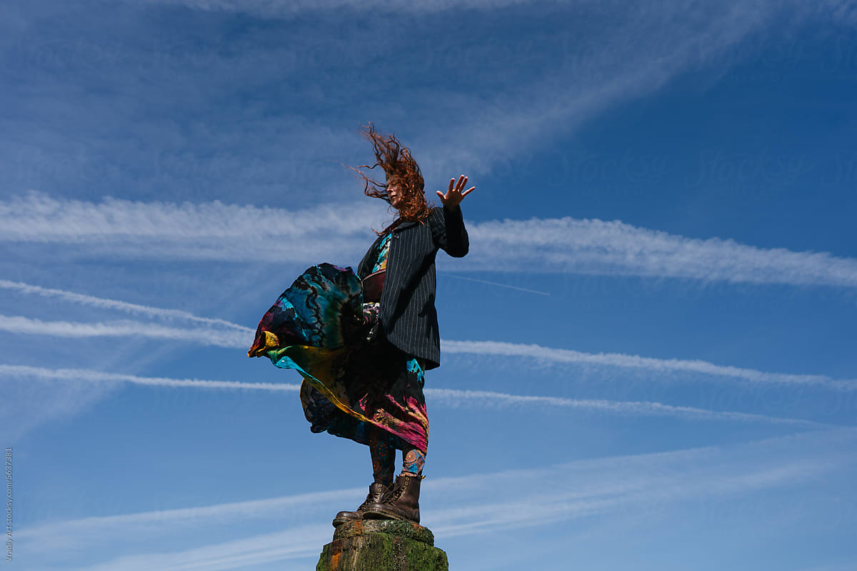 Young woman on a bridge against blue sky