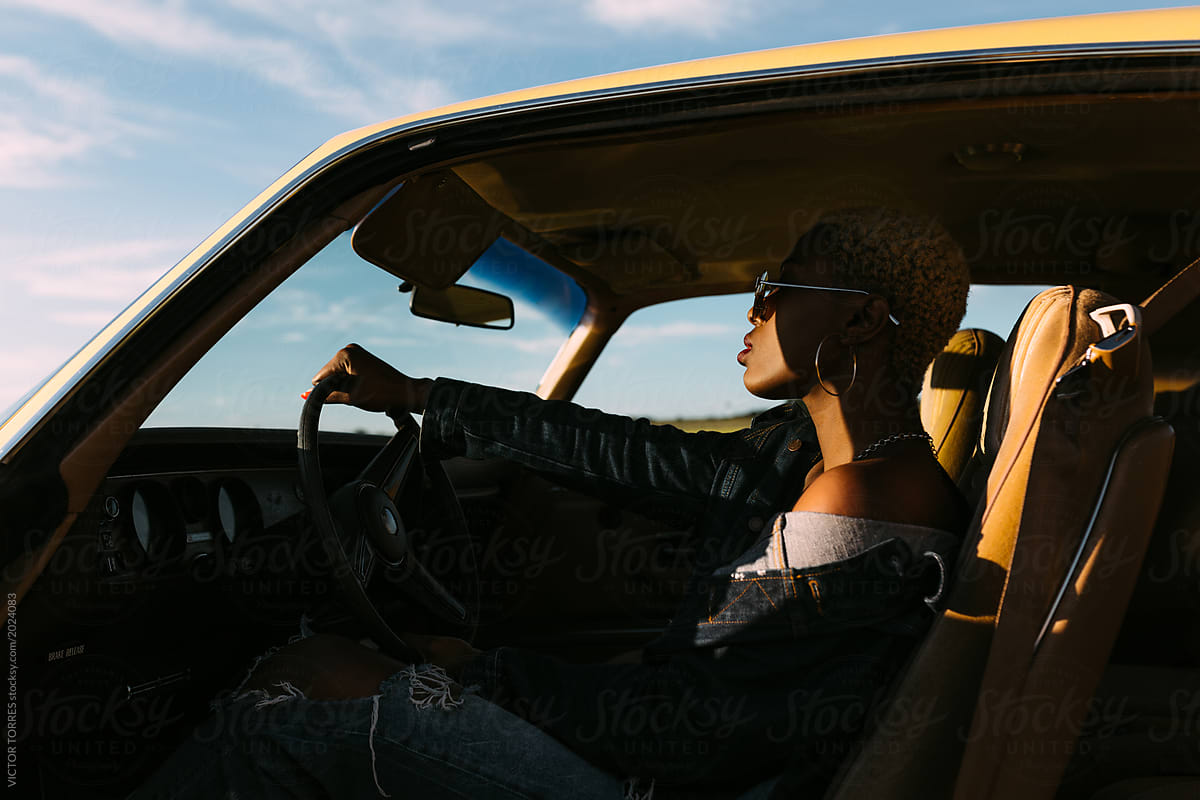 Cool blonde african black woman inside a car
