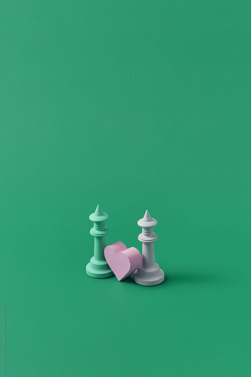 Two chess pieces of different color with heart.