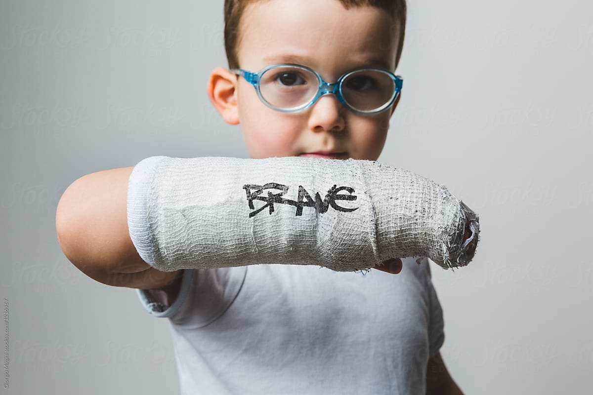 Brave Kid Showing the Written Arm Cast