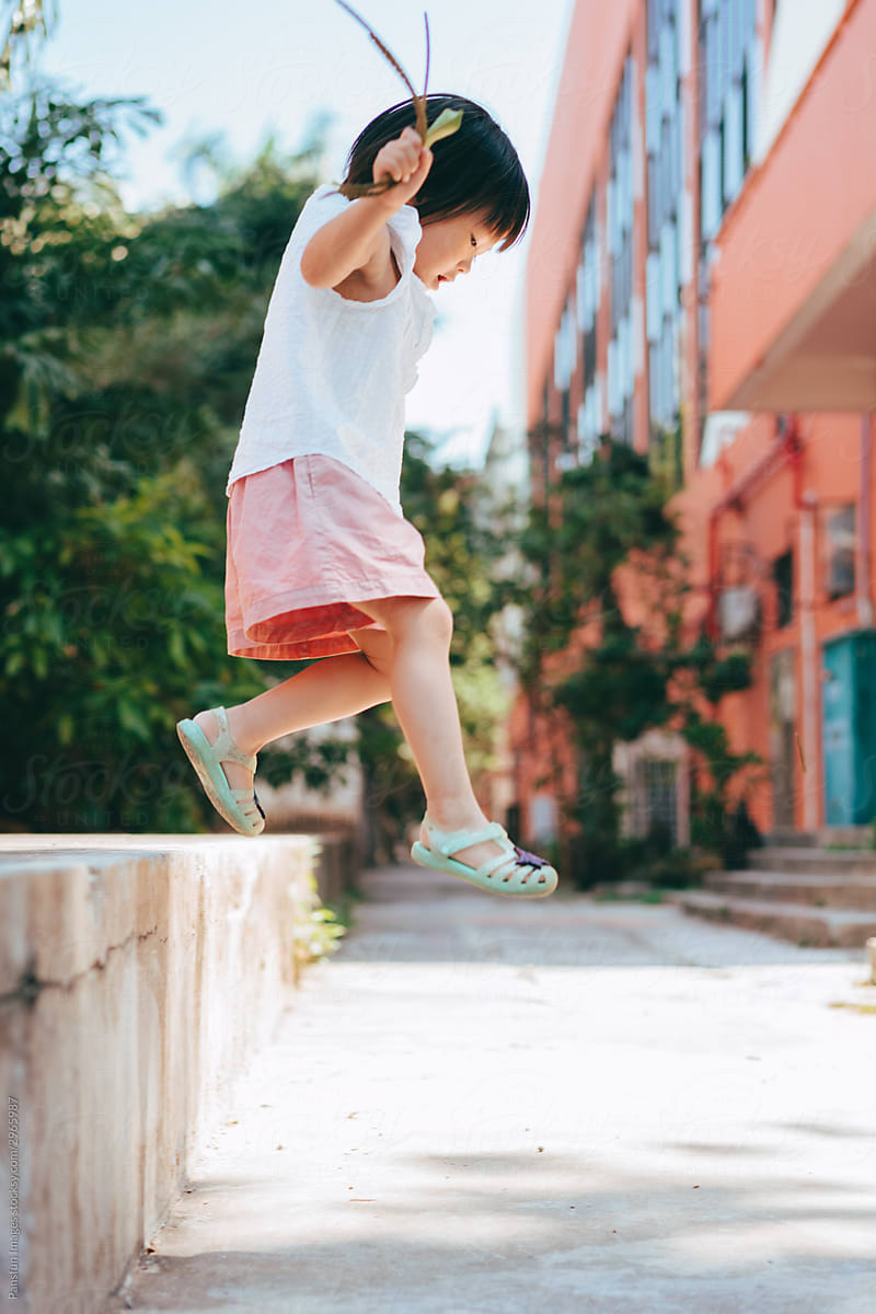 little girl jumping outdoor