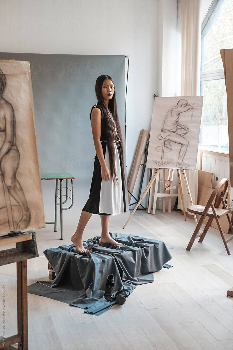 Asian Woman Wearing Black And White Dress Posing In The Art Studio