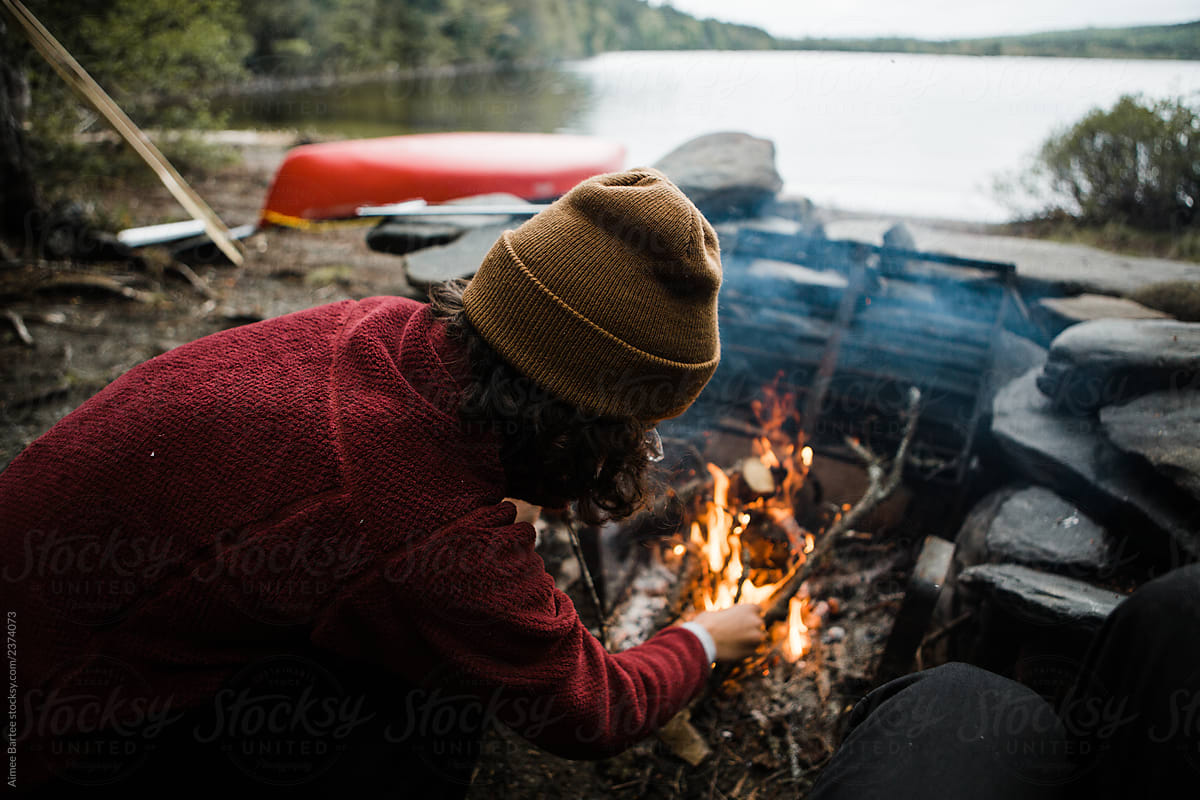 Woman Tending to Campfire