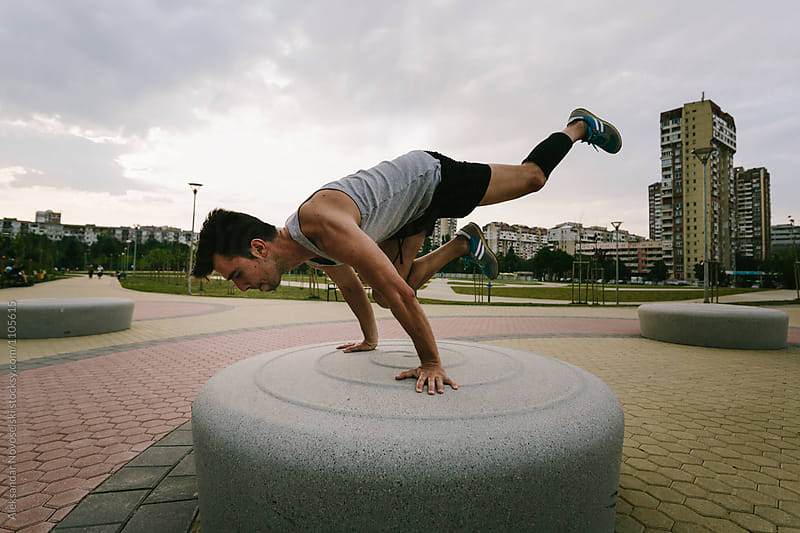 Young athletic man working out in urban environment