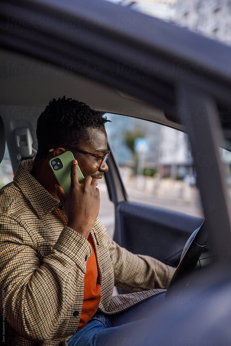 Entrepreneur on a phone call while getting into car