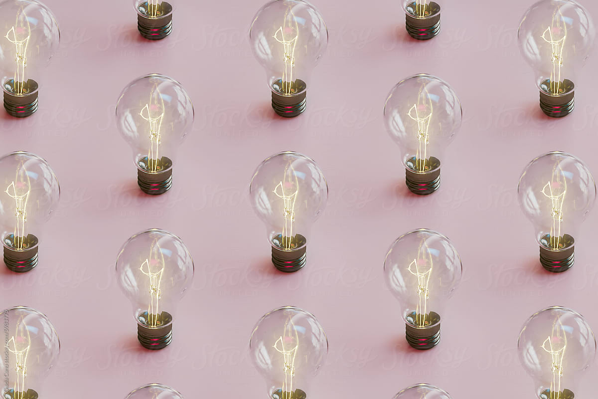 Pattern of Illuminated Light Bulbs on Pink Background