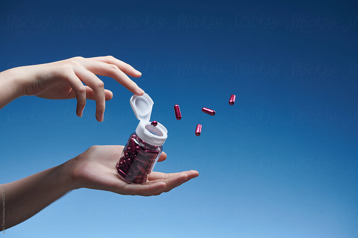The bottle in hand with purple pills flies out