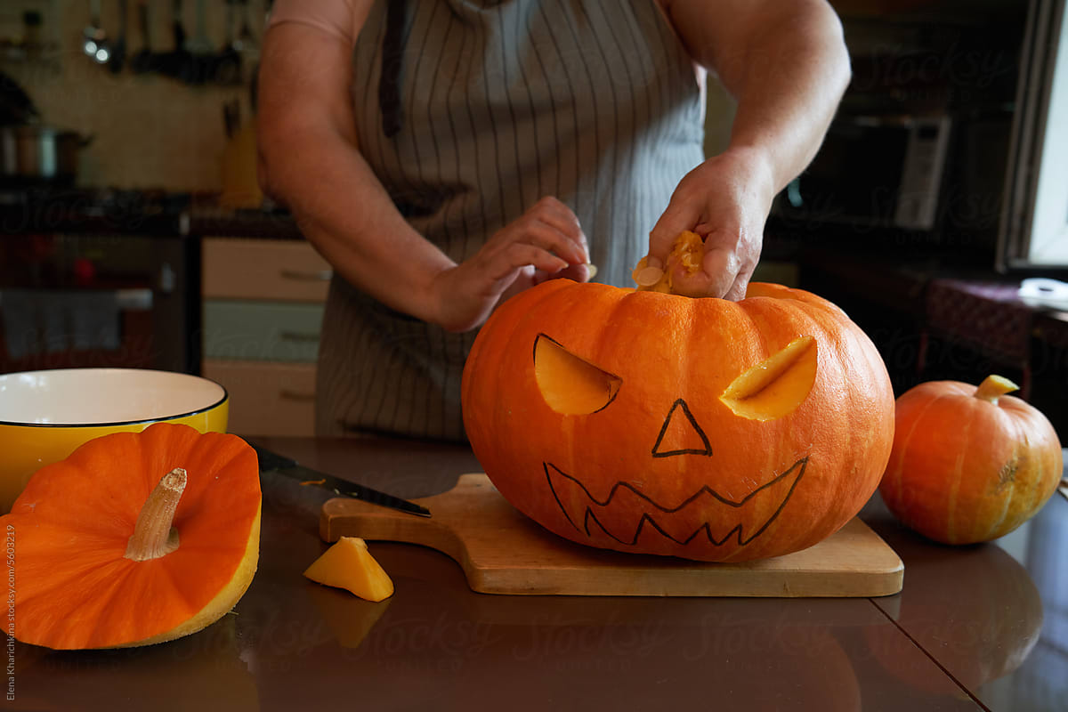 Carving: Woman Working On Face Of Jack-O-Lantern