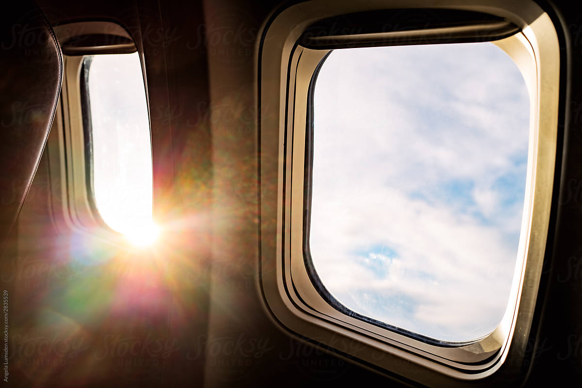 Airplane window seat sunlight flare