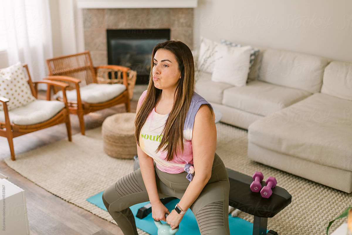 Active curvy woman exercising at home