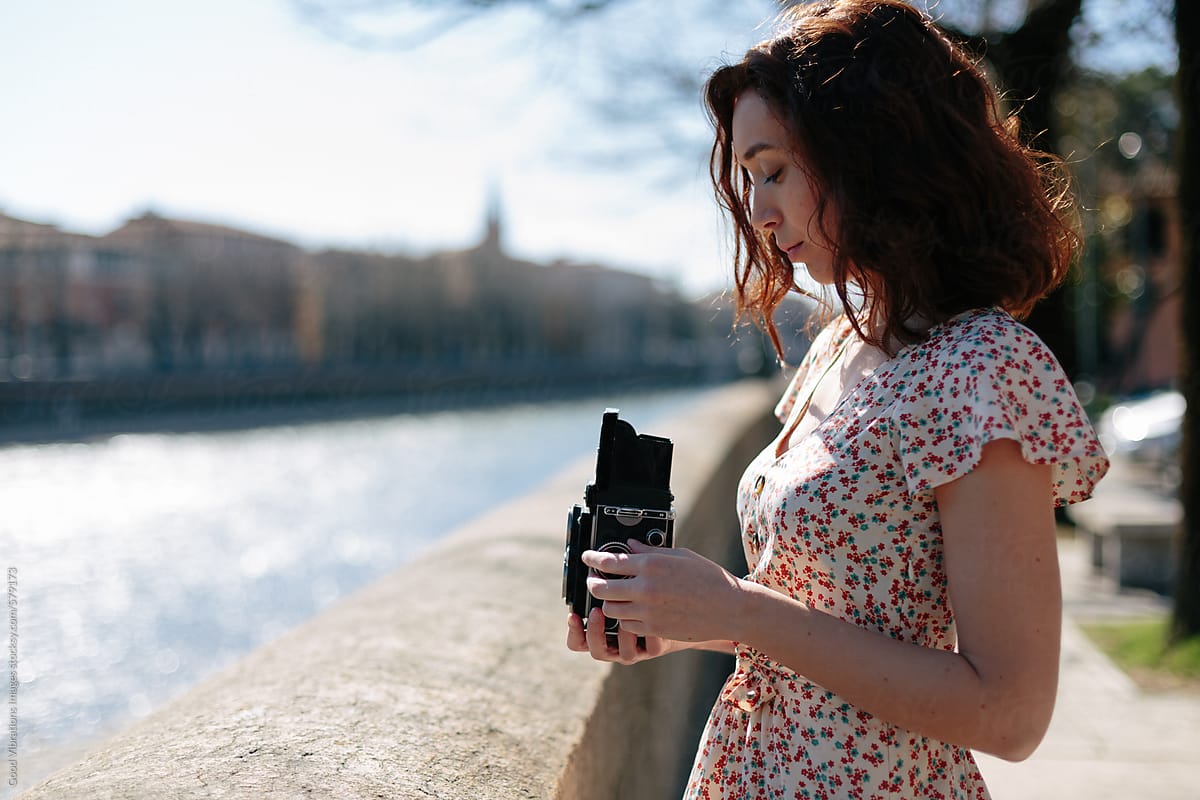 Beautiful woman holding a vintage camera