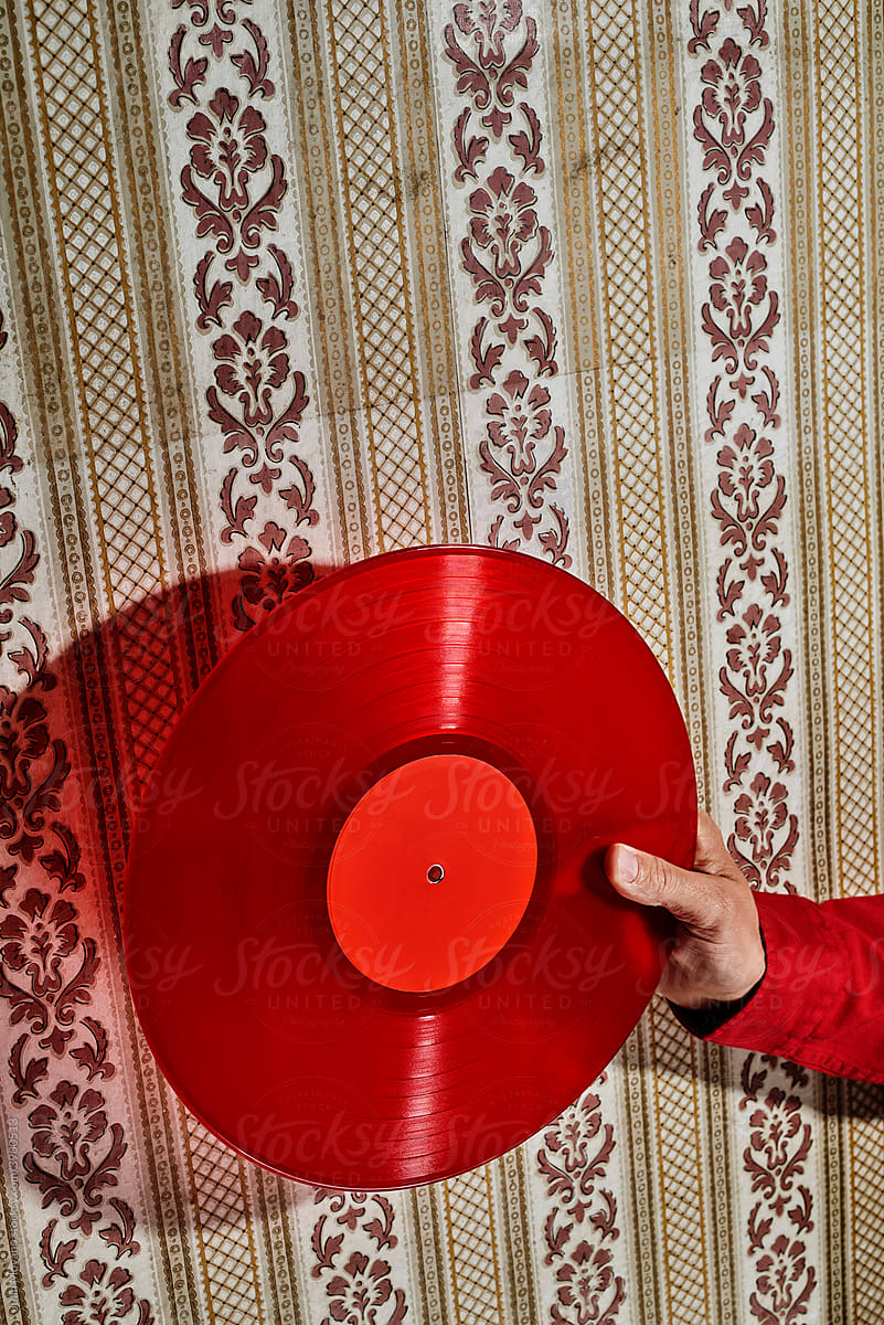 man grabbing a red disc