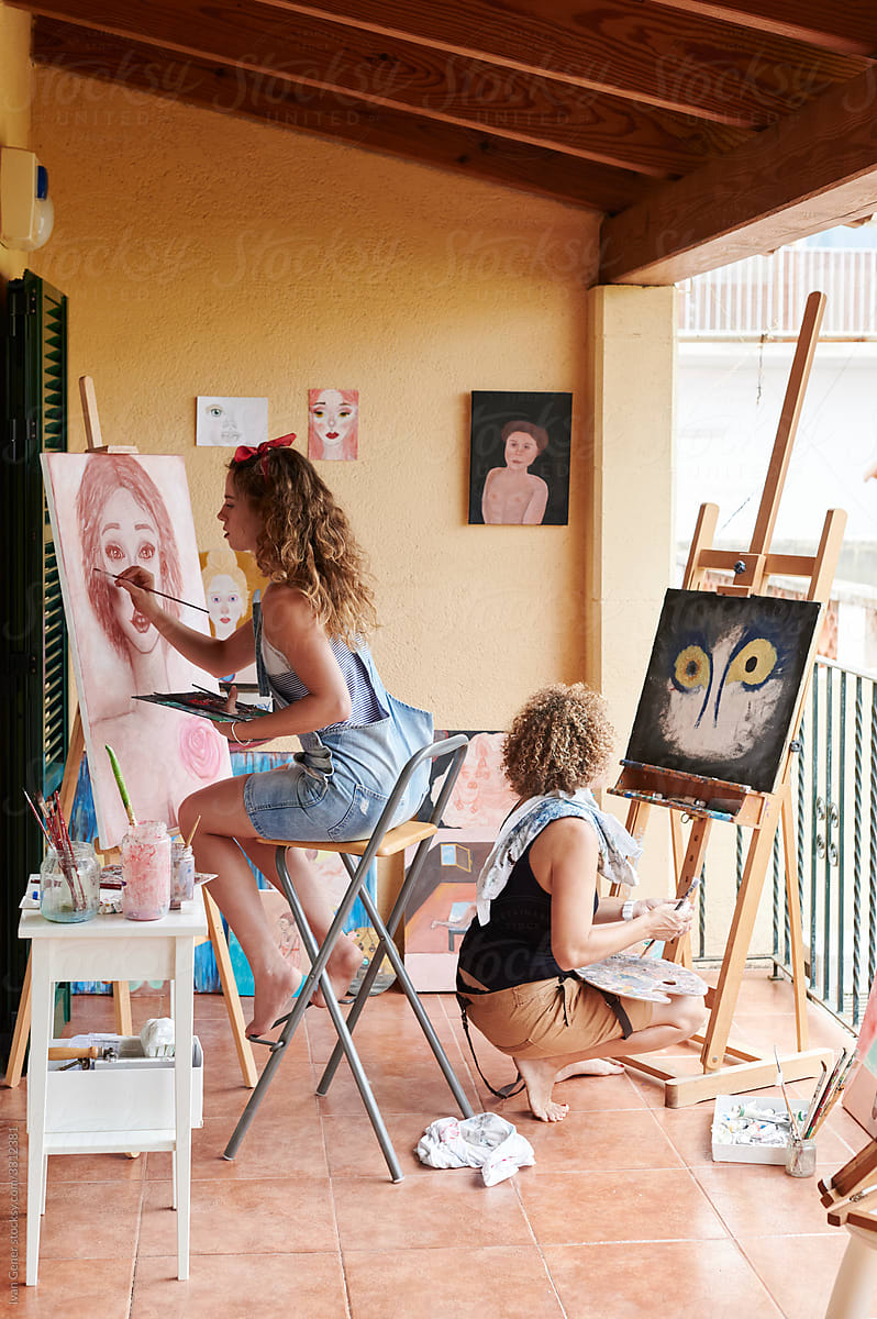 Woman and mom painting in their art space