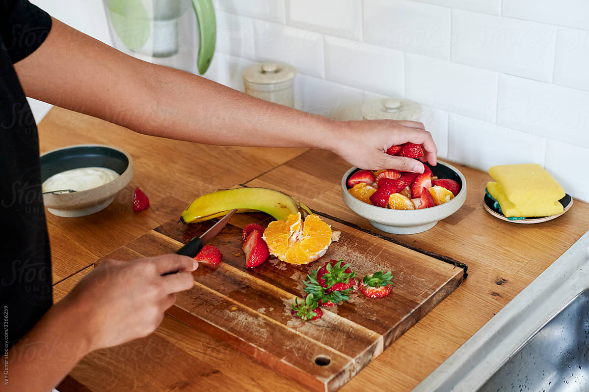 Woman making a fruit salad for breakfast