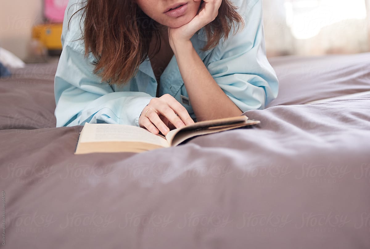 Crop Woman Reading Book On Bed By Guille Faingold 5719