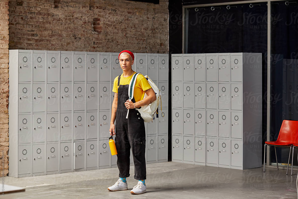 Portrait Of Student With Backpack Against Locker